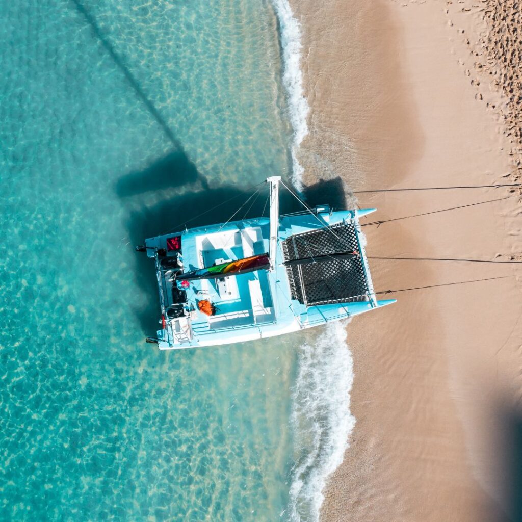 a catamaran docked on a beach