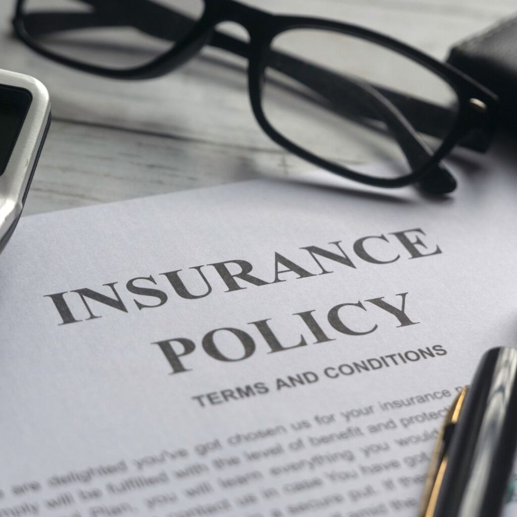 an insurance policy with pens on top